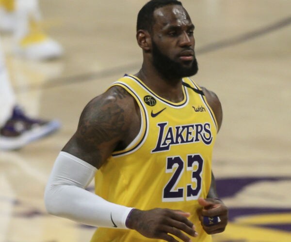 lebron james is shown in his los angeles lakers uniform in the staples center