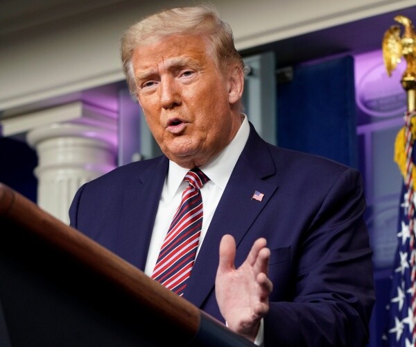 donald trump speaks at podium