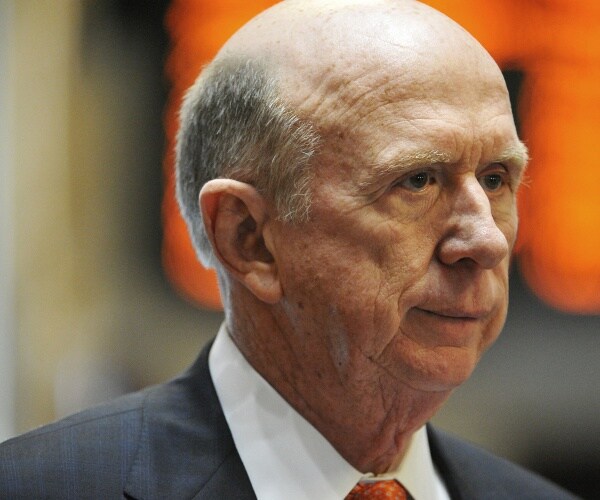 wilkins in a gray suit and orange tie