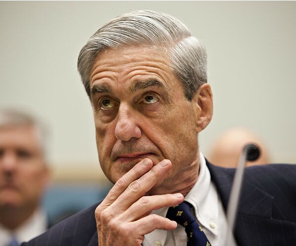 robert mueller listens with his right hand holding up his chin and his first two fingers covering his mouth