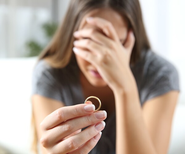 A woman holding her wedding ring
