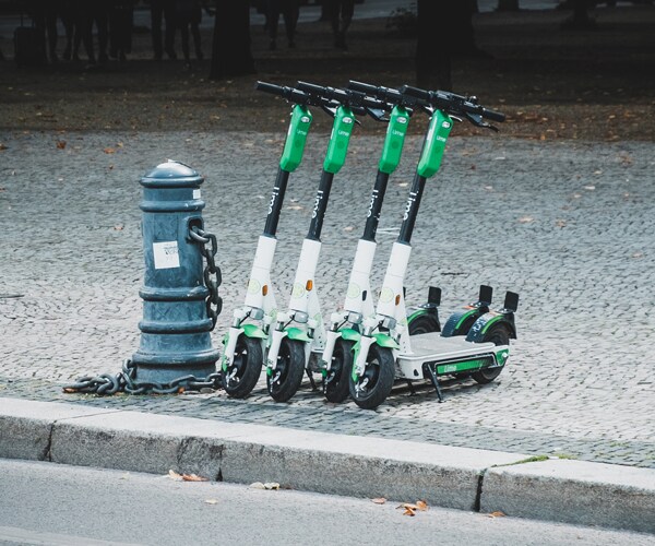 electric scooters parked on a sidewalk
