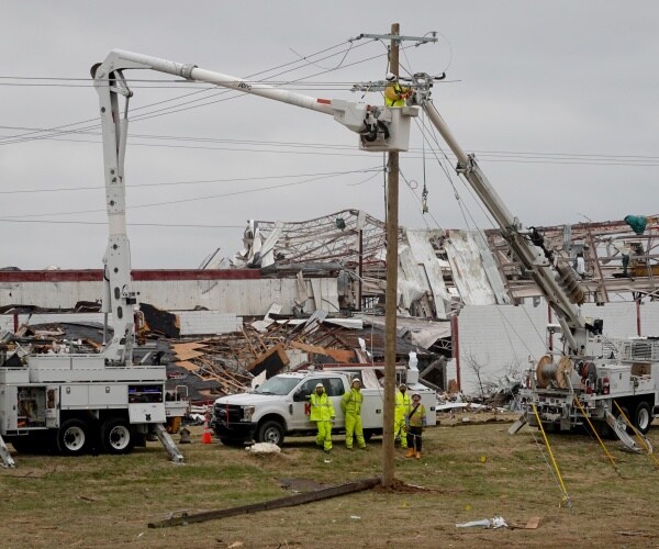 Lineman work to restore power to residents.