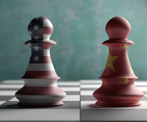 u.s. and china pawns face off on a chess board