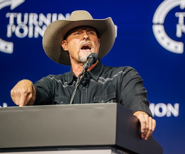 mark lamb speaks into mic