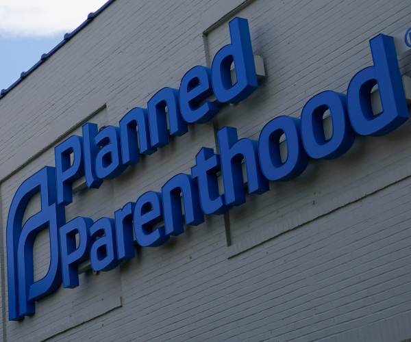 A planned parenthood sign on the side of a building.