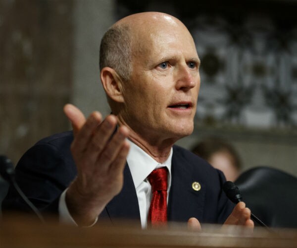 sen. rick scott gestures as he speaks on capitol hill 