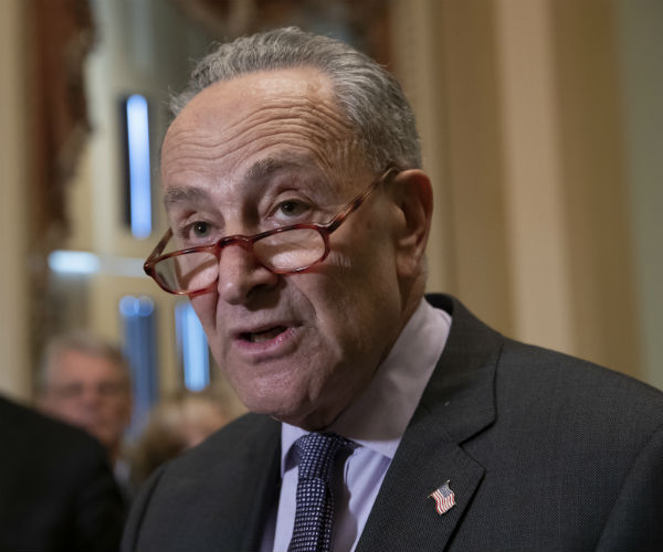 Senate Minority Leader Chuck Schumer is shown with his glasses on, but tipping off his nose