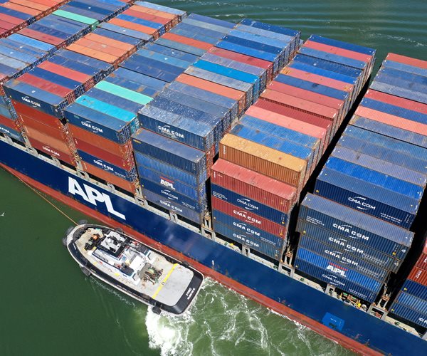 shipping containers are stacked in port of oakland