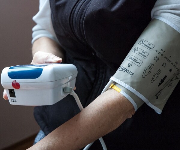 woman measuring her blood pressure