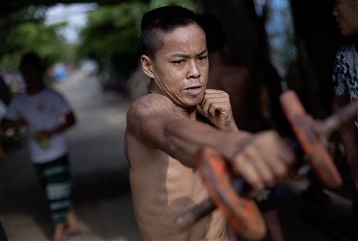 AP PHOTOS: Myanmar Athletes Train amid Traffic