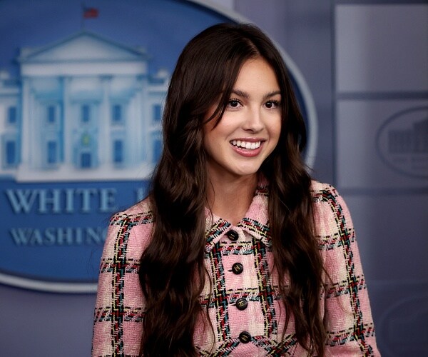 olivia rodrigo stands in press briefing room