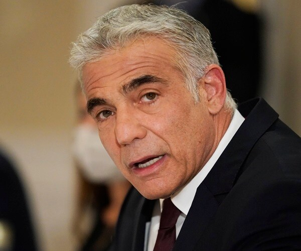 Yair Lapid looks on