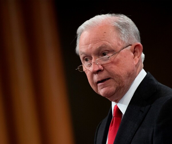 jeff sessions in a red tie during a press conference