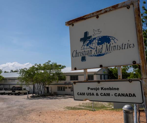 a sign outside a building with vans