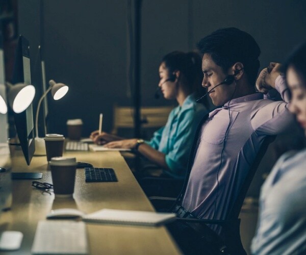 young adults in office working late