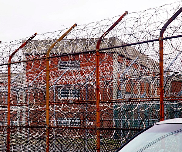 the jail at rikers island behind a snarl of barbed wire