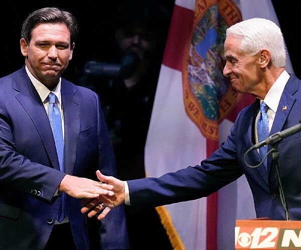 desantis and crist shake hands on stage