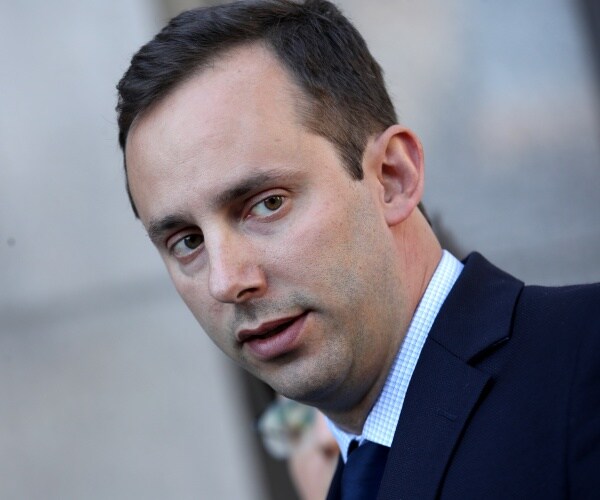 levandowski in a suit looking to the side