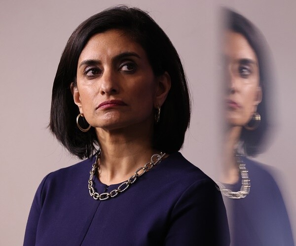 seema verma stands in the white house briefing room listening to others speak