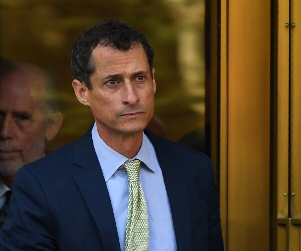 weiner in a suit light blue shirt and green tie