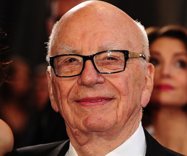 Rupert Murdoch grimaces in a public appearance