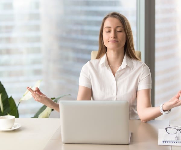 woman at work practicing breathing exercises