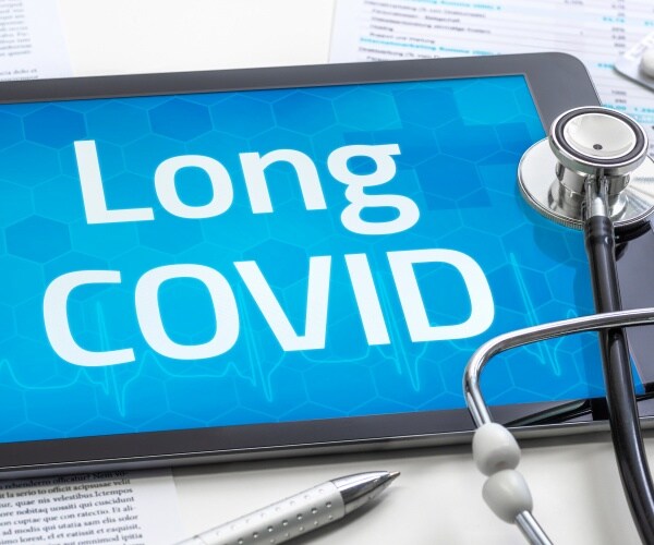 tablet with "Long COVID" on screen, stethoscope