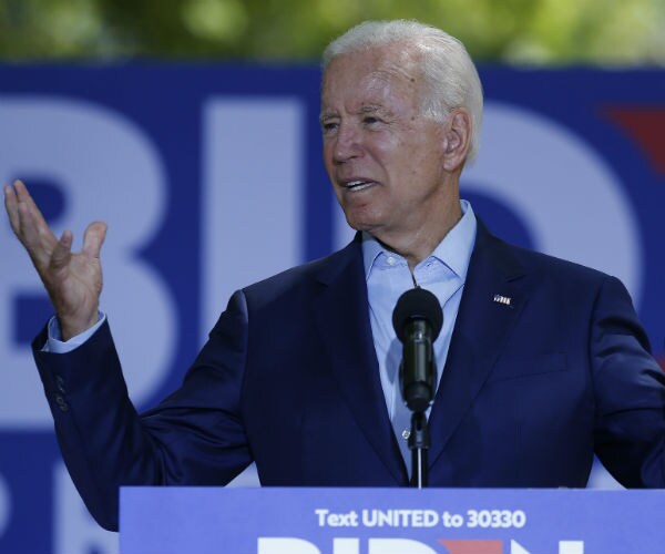 Former Vice President Joe Biden is shown on the campaign trail in a blue suit and button-down shirt.