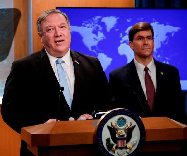 esper in a suit and red tie standing by as pompeo speaks