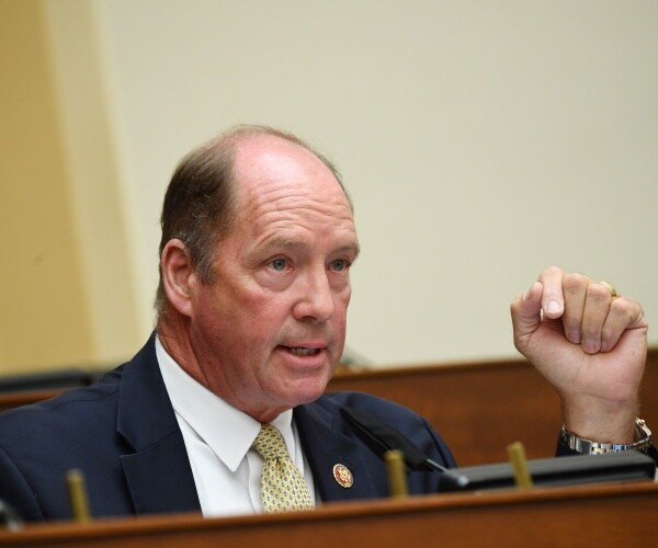 yoho in a suit and yellow tie