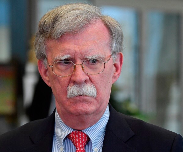 john bolton stands and listens