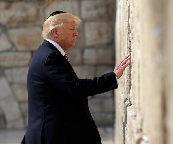 president donald trump touches the holy western wall with his left hand