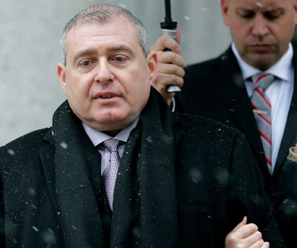 lev parnas stands in the rain for a news conference