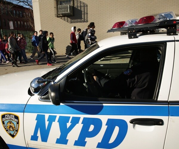 nypd patrol car parked outside a middle school