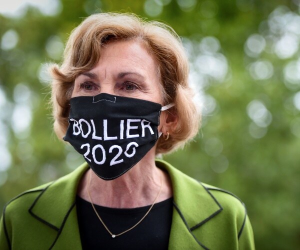 bollier in a green jacket and black top wearing a bollier 2020 mask