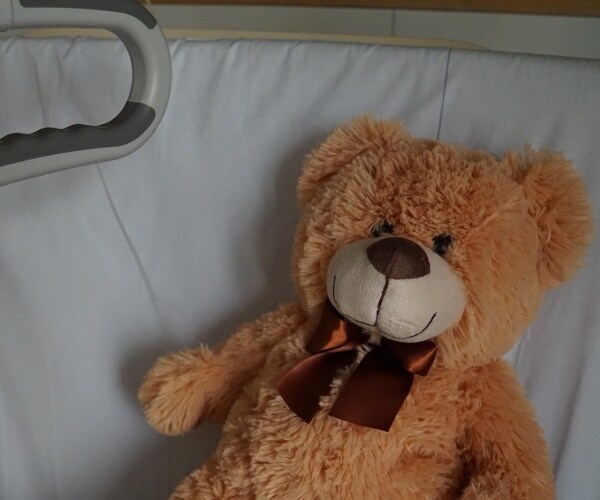 teddy bear in hospital bed