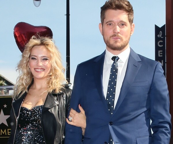 michael bluble and his wife luisana stand by the hollywood walk of fame