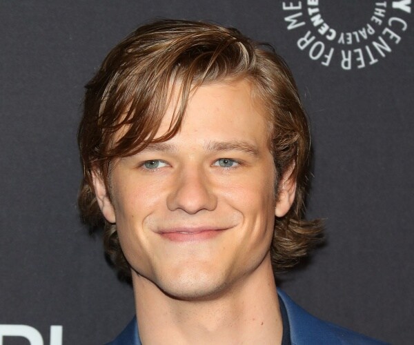 till wearing a blue coat smiling