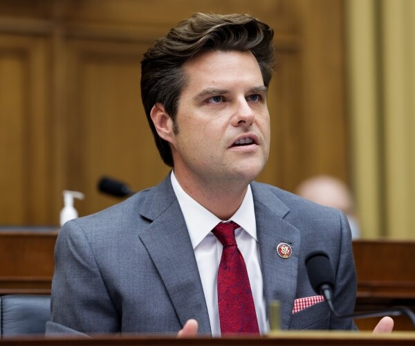 gaetz in a gray suit and red tie