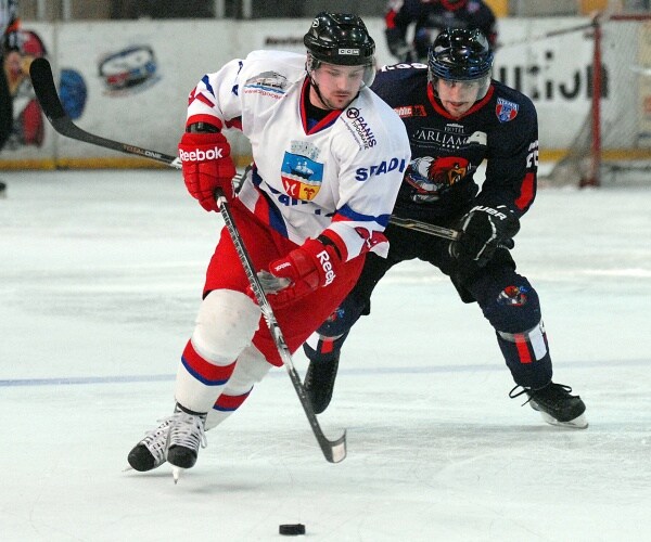 people playing ice hockey in a stadium
