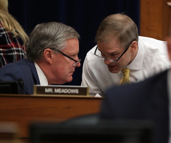 mark meadows lean into each other to talk during a house oversight committee hearing