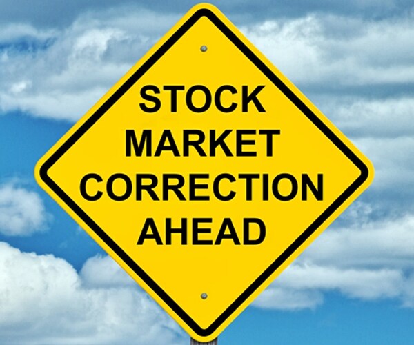 Stock Market Correction Ahead on Yellow Caution Sign With Black Print with Blue Sky Background