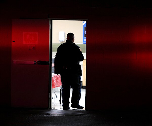 A police officer walks into a Walmart where a gunman opened fire in a shopping complex 
