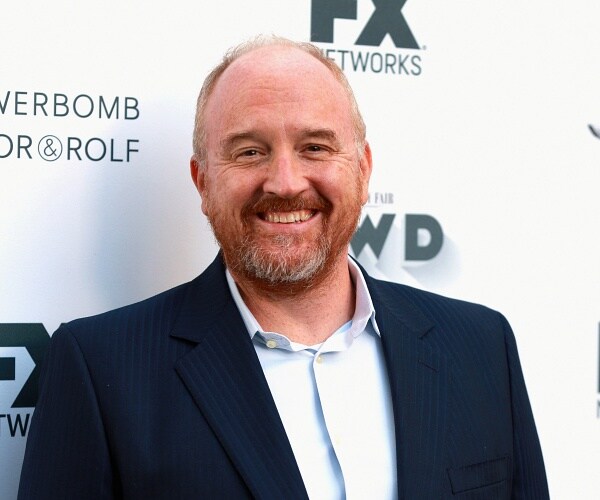 louis ck stands on red carpet