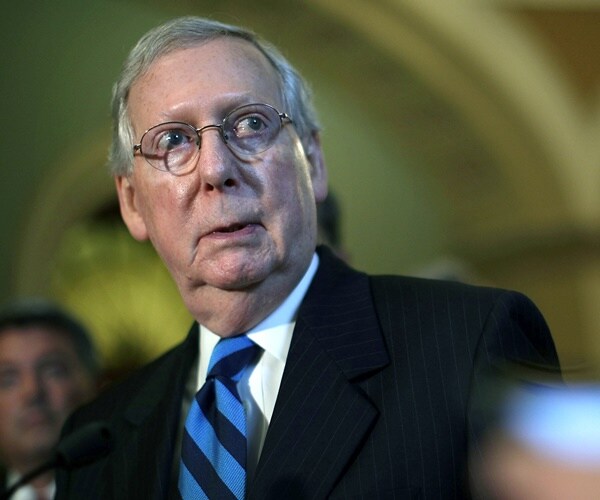 sen. mitch mcconnell listens during a press briefing