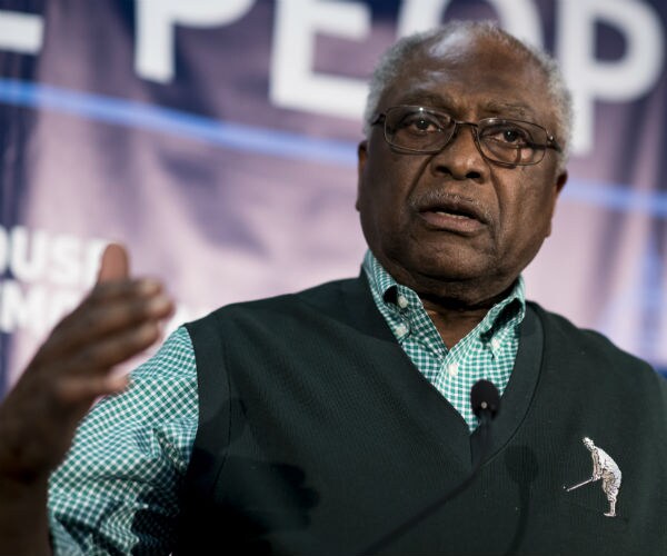 House Majority Whip Jim Clyburn is shown in a green shirt and green Polo sweater vest