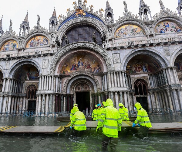 workers in front of st marks basilica in venice, italy