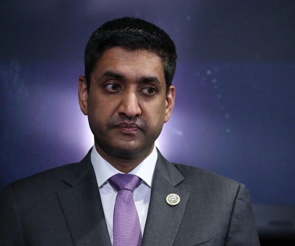 khanna in a gray suit and purple tie