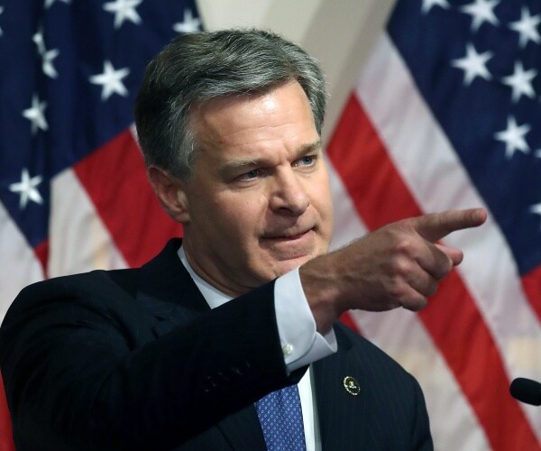 Christopher A. Wray speaks to the media 